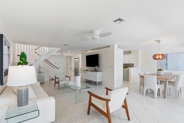 living room with ceiling fan and light tile patterned floors