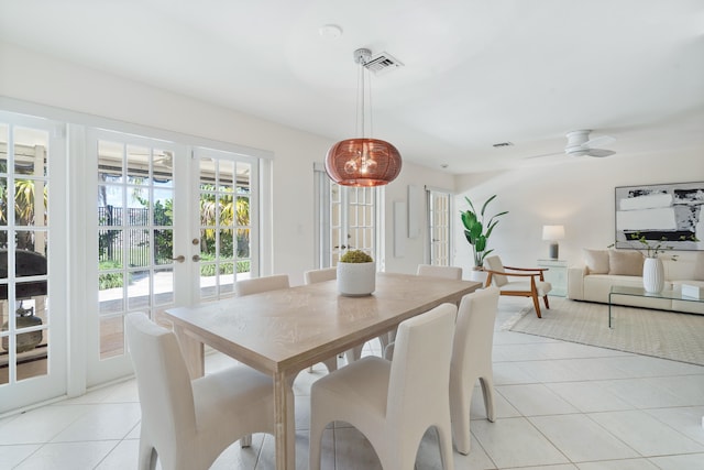 tiled dining area featuring french doors and ceiling fan