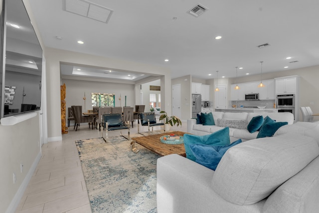 living area featuring light tile patterned floors, visible vents, and recessed lighting