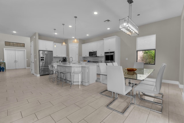 dining space with a notable chandelier and sink