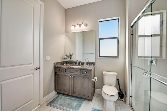 bathroom featuring vanity, toilet, and an enclosed shower