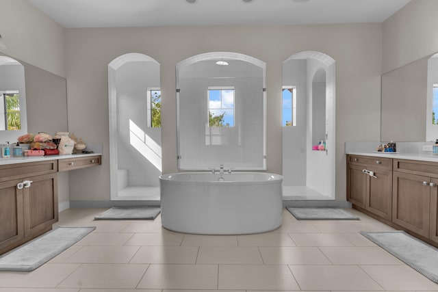 bathroom with vanity, plus walk in shower, and tile patterned floors