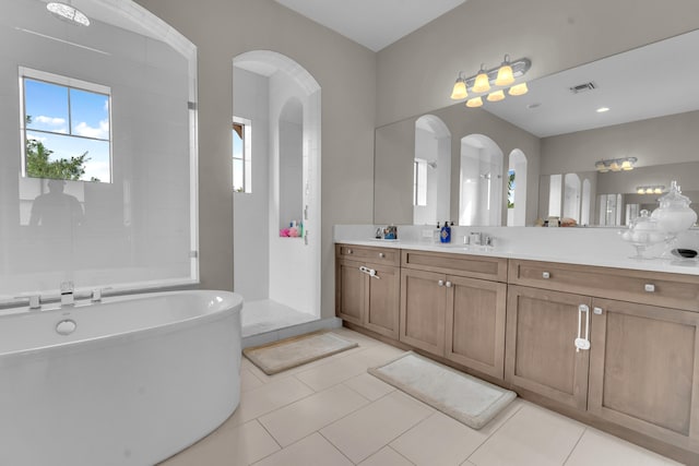 bathroom with plus walk in shower, tile patterned flooring, and vanity