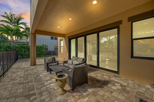 patio terrace at dusk featuring outdoor lounge area