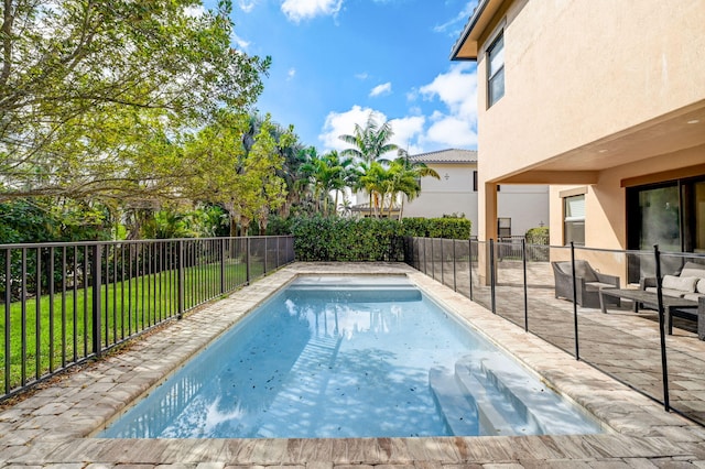 view of swimming pool with a lawn and a patio