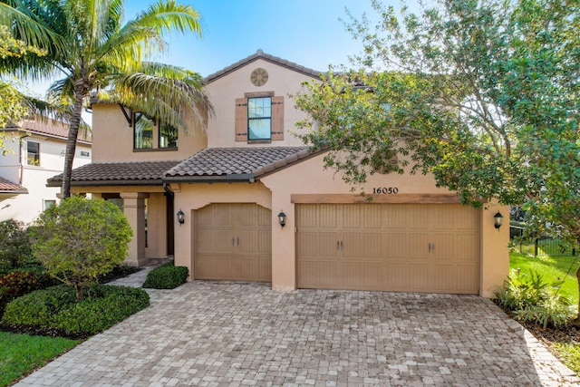 mediterranean / spanish-style home with a garage