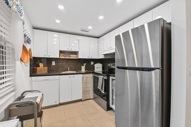 389 Capri I, Delray Beach, FL 33484 - kitchen featuring tasteful backsplash, stainless steel appliances, light tile patterned floors, and white cabinets