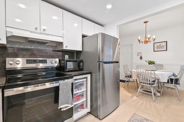 kitchen with light tile patterned flooring, an inviting chandelier, white cabinets, appliances with stainless steel finishes, and decorative light fixtures