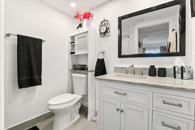 bathroom featuring vanity and toilet