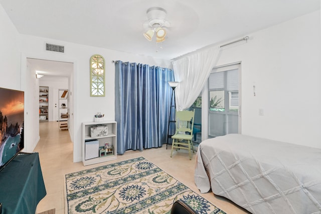 tiled bedroom featuring ceiling fan