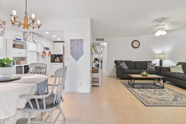 dining space featuring ceiling fan with notable chandelier and light tile patterned floors