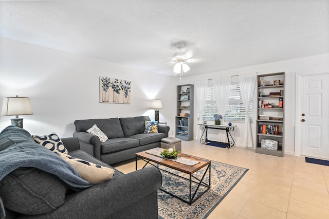 living room featuring light tile patterned floors and ceiling fan