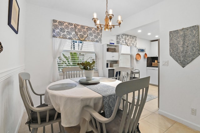 dining space with an inviting chandelier and light tile patterned floors