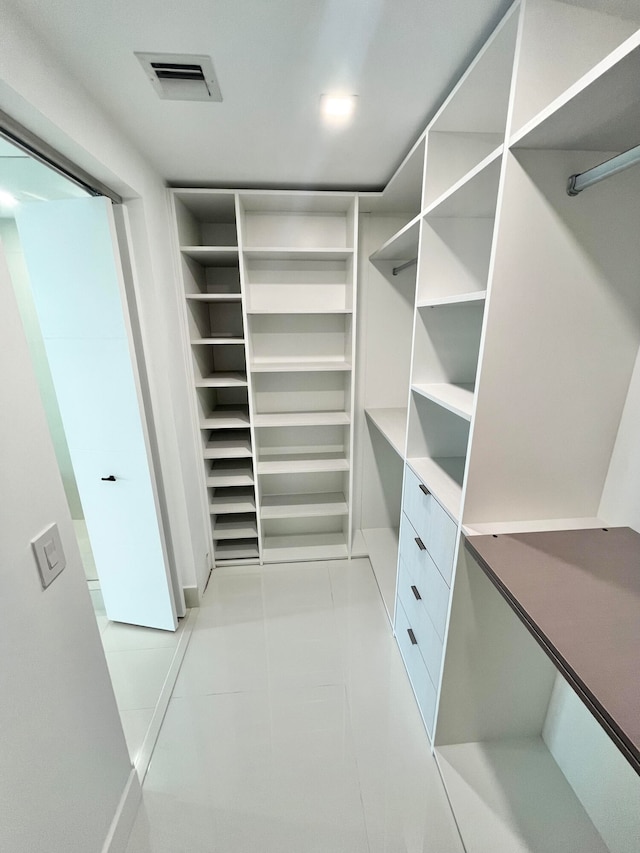 spacious closet featuring light tile patterned flooring