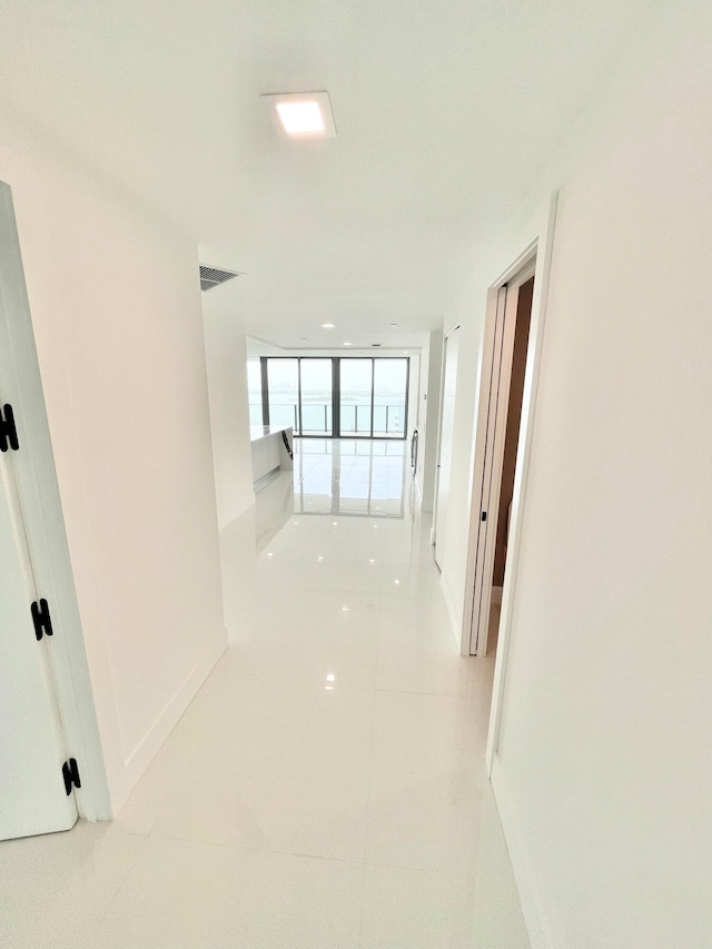 corridor with light tile patterned flooring