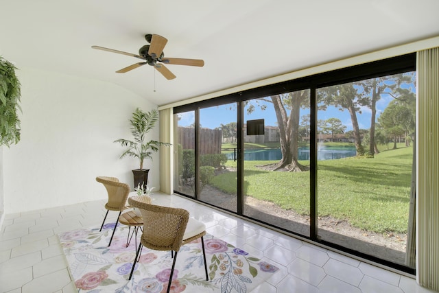 sunroom with a water view, ceiling fan, and lofted ceiling