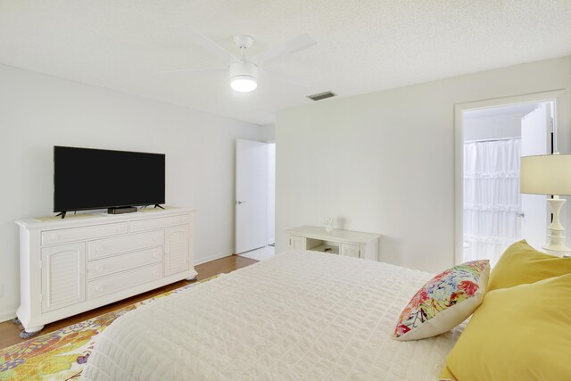 bedroom with hardwood / wood-style floors, access to exterior, ceiling fan, and a closet