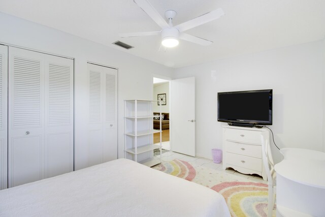 tiled bedroom featuring ceiling fan and a textured ceiling