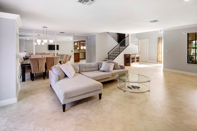 living room with ornamental molding and light tile patterned floors