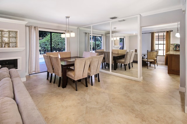 dining room with light tile patterned flooring, crown molding, a chandelier, and a wealth of natural light