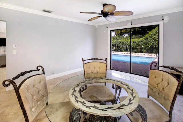 tiled dining area featuring crown molding and ceiling fan