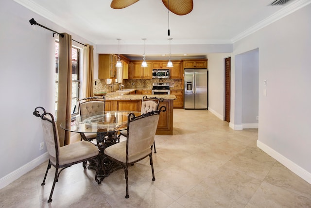 tiled dining space featuring ornamental molding and ceiling fan