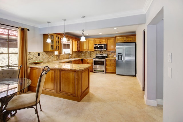 kitchen featuring tasteful backsplash, pendant lighting, light stone countertops, appliances with stainless steel finishes, and kitchen peninsula