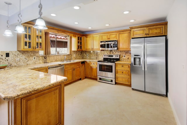 kitchen featuring tasteful backsplash, stainless steel appliances, pendant lighting, sink, and light stone counters