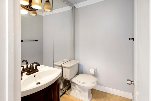 bathroom with tile patterned floors, vanity, ornamental molding, and toilet