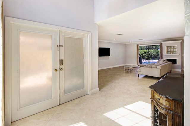 foyer entrance featuring ornamental molding and light tile patterned floors