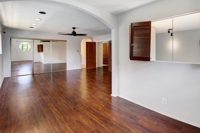 spare room with a textured ceiling, ceiling fan, and hardwood / wood-style floors