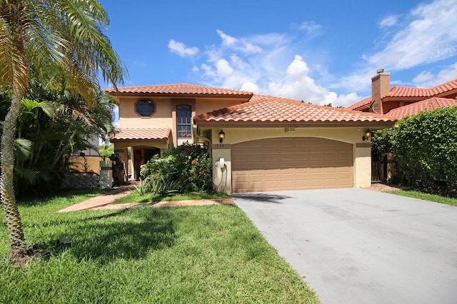 mediterranean / spanish-style home with a garage and a front lawn