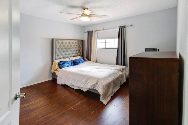 bedroom with a textured ceiling, ceiling fan, and hardwood / wood-style floors