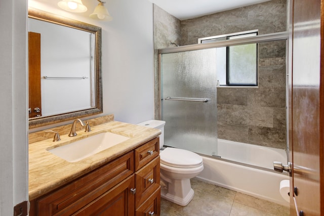 full bathroom with vanity, combined bath / shower with glass door, tile patterned floors, and toilet