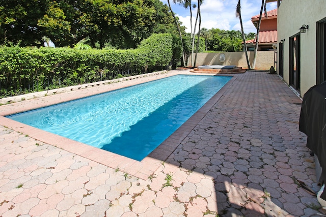 view of swimming pool with a patio