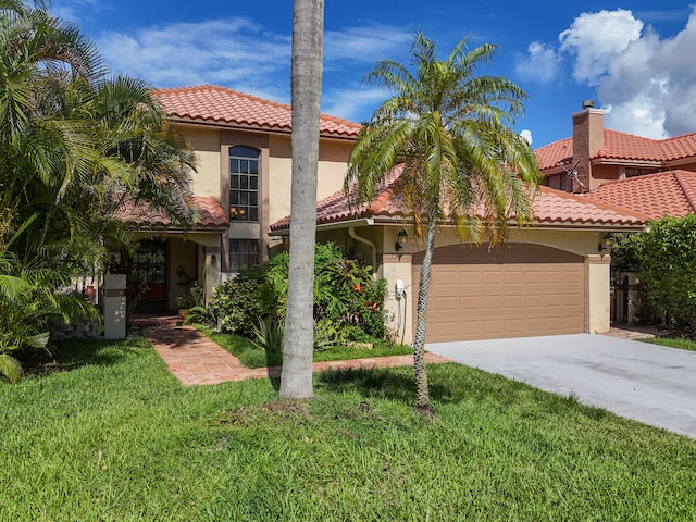 mediterranean / spanish house with a garage and a front yard