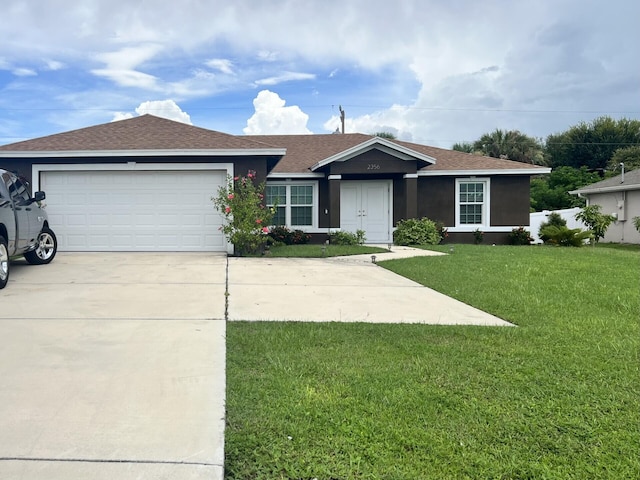 single story home with a garage and a front lawn