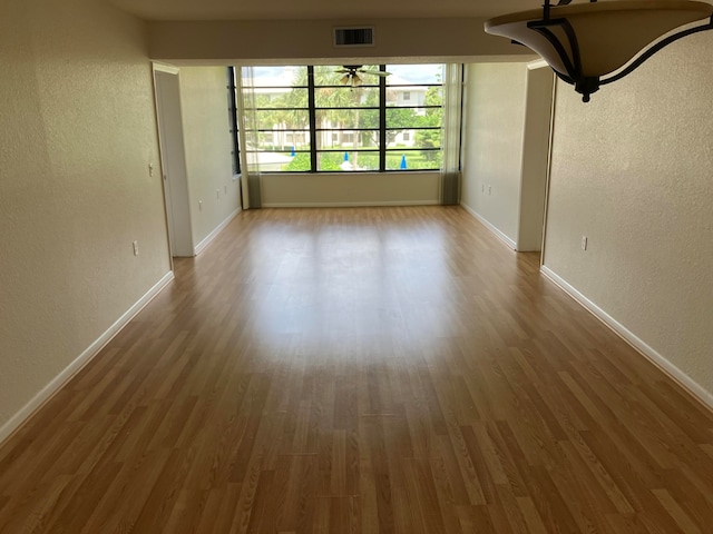 empty room with dark hardwood / wood-style flooring