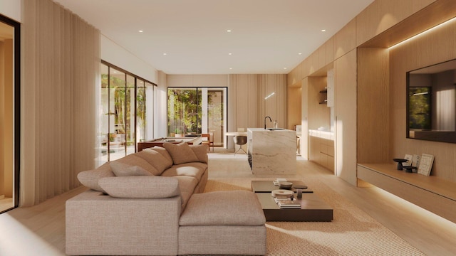 living room featuring sink and light hardwood / wood-style flooring