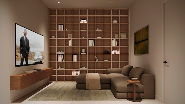 cinema room with built in shelves and light tile patterned floors