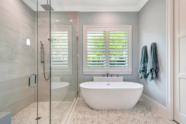 bathroom featuring plus walk in shower and tile patterned flooring