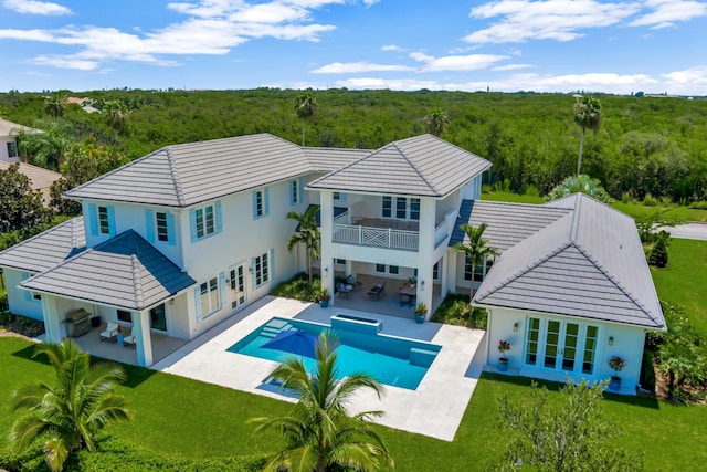 view of swimming pool featuring a patio and french doors