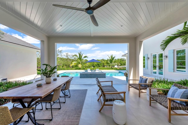 view of patio / terrace with a pool with hot tub, an outdoor living space, and ceiling fan