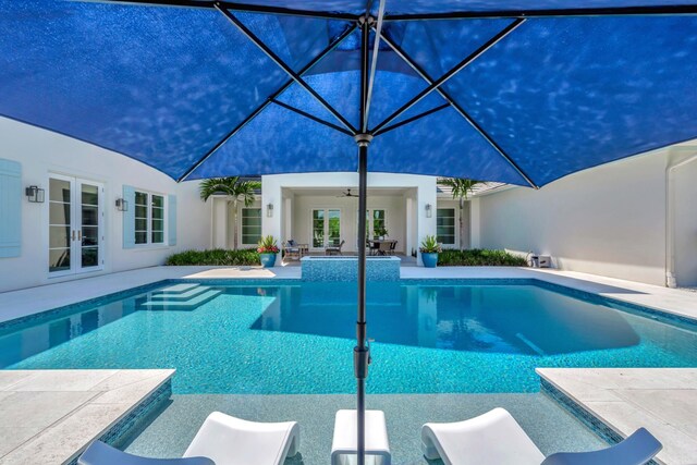 view of pool featuring a patio area and ceiling fan