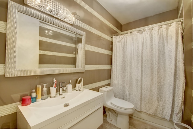 bathroom featuring tile patterned floors, vanity, and toilet