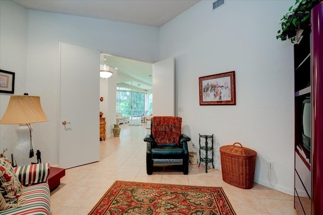 living room with light tile patterned floors and vaulted ceiling