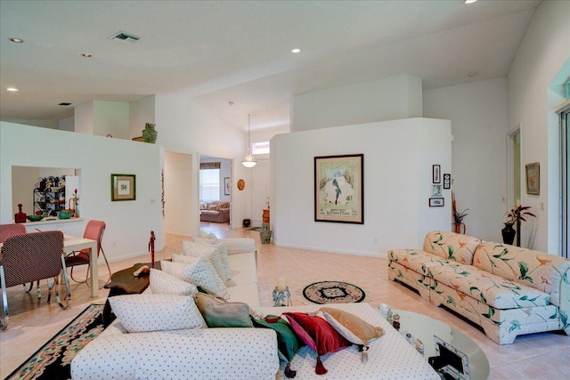 tiled living room featuring high vaulted ceiling