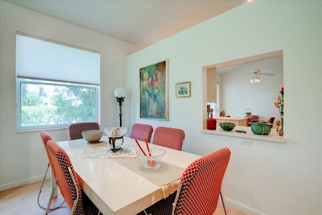 tiled dining space with ceiling fan