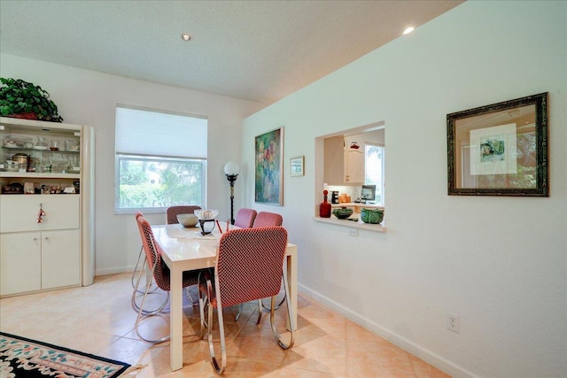 dining area featuring light tile patterned flooring