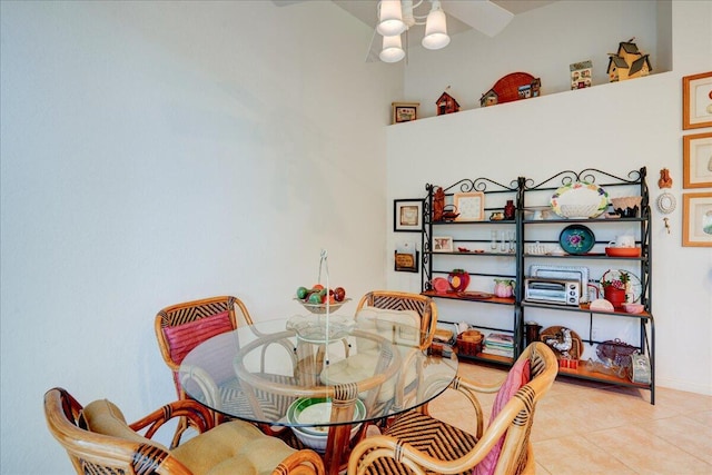 dining space with light tile patterned flooring and ceiling fan